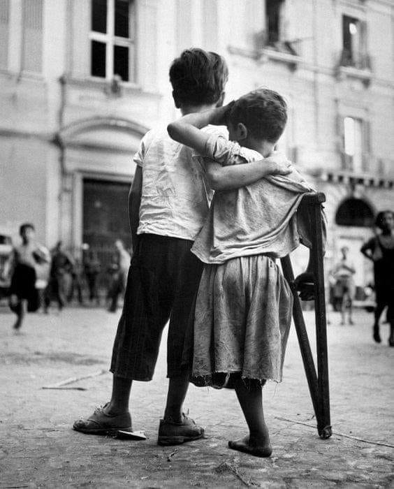 Boy Helps Amputee Friend Injured in War in Naples, Italy - By Henri Cartier Bresson, 1944