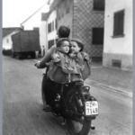 Kids in a back pack on a bike