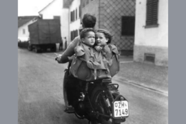 Kids in a back pack on a bike